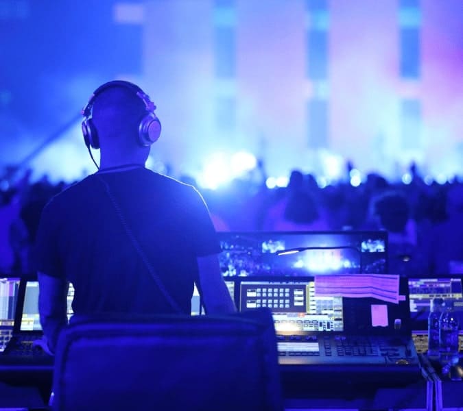 CTS audio engineer working a sound board during a live performance