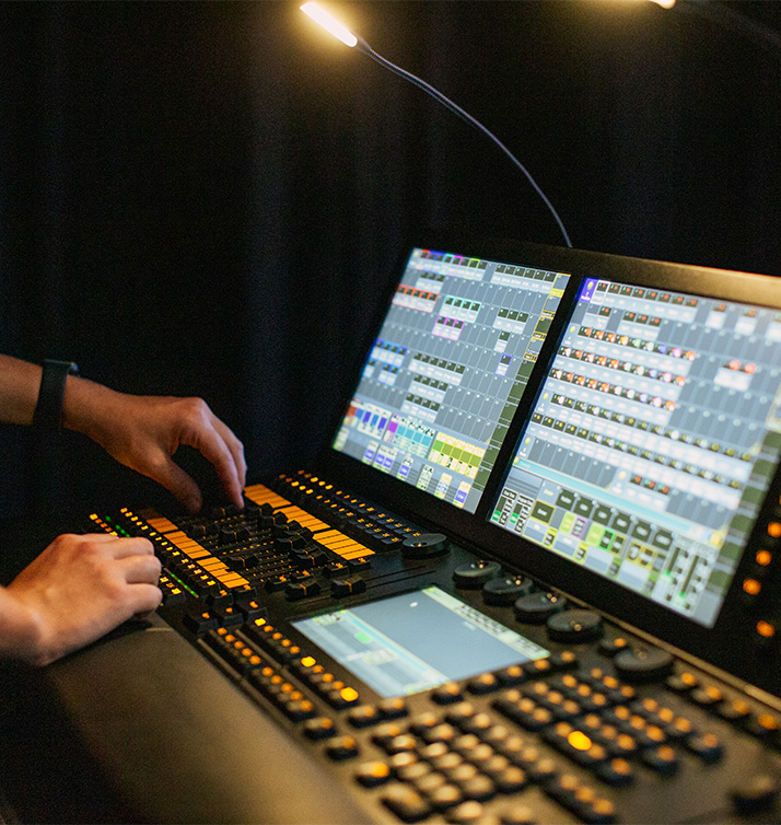 CTS audio engineer working a sound board during a live performance