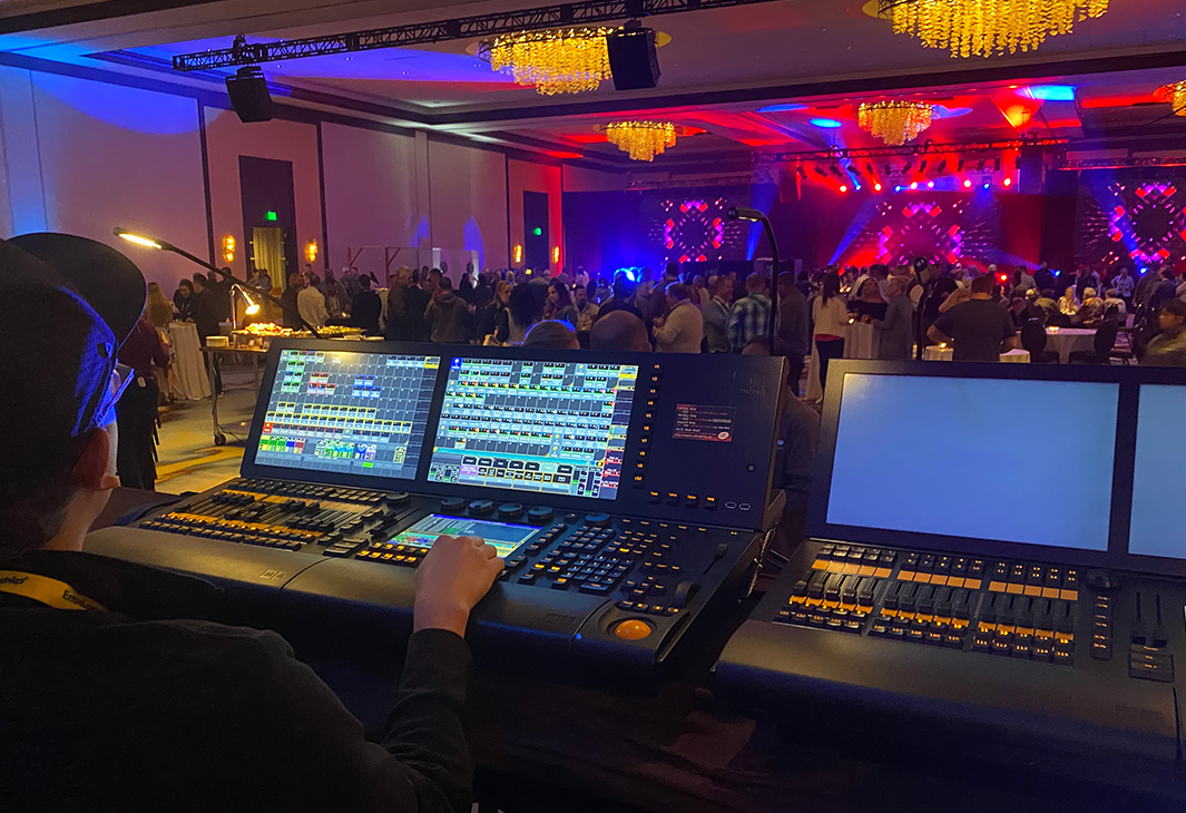 CTS audio engineer working a sound board during a live performance