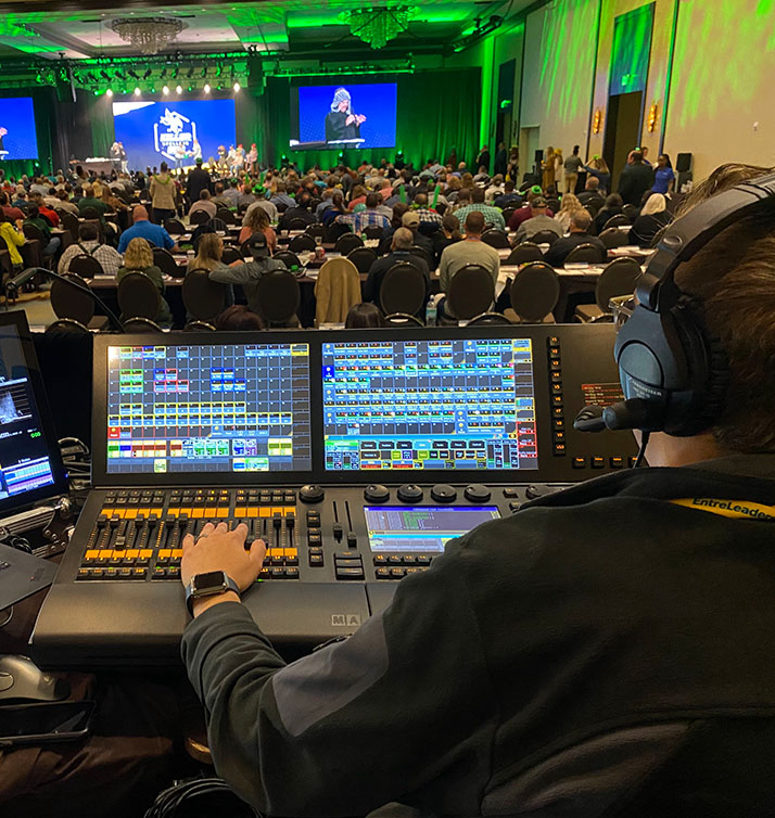 CTS audio engineer working a sound board during a live performance