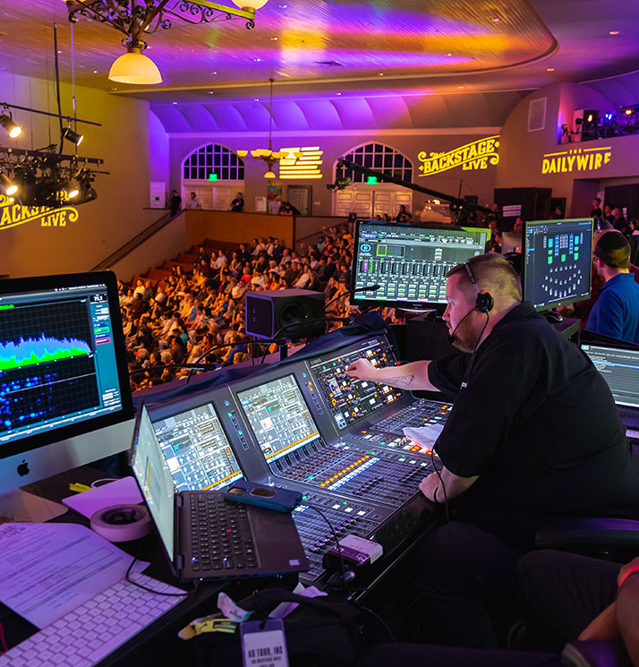 CTS audio engineer working a sound board during a live performance