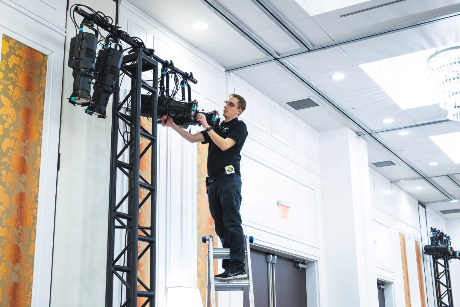 CTS AVL team member assembling lighting rig for a live event